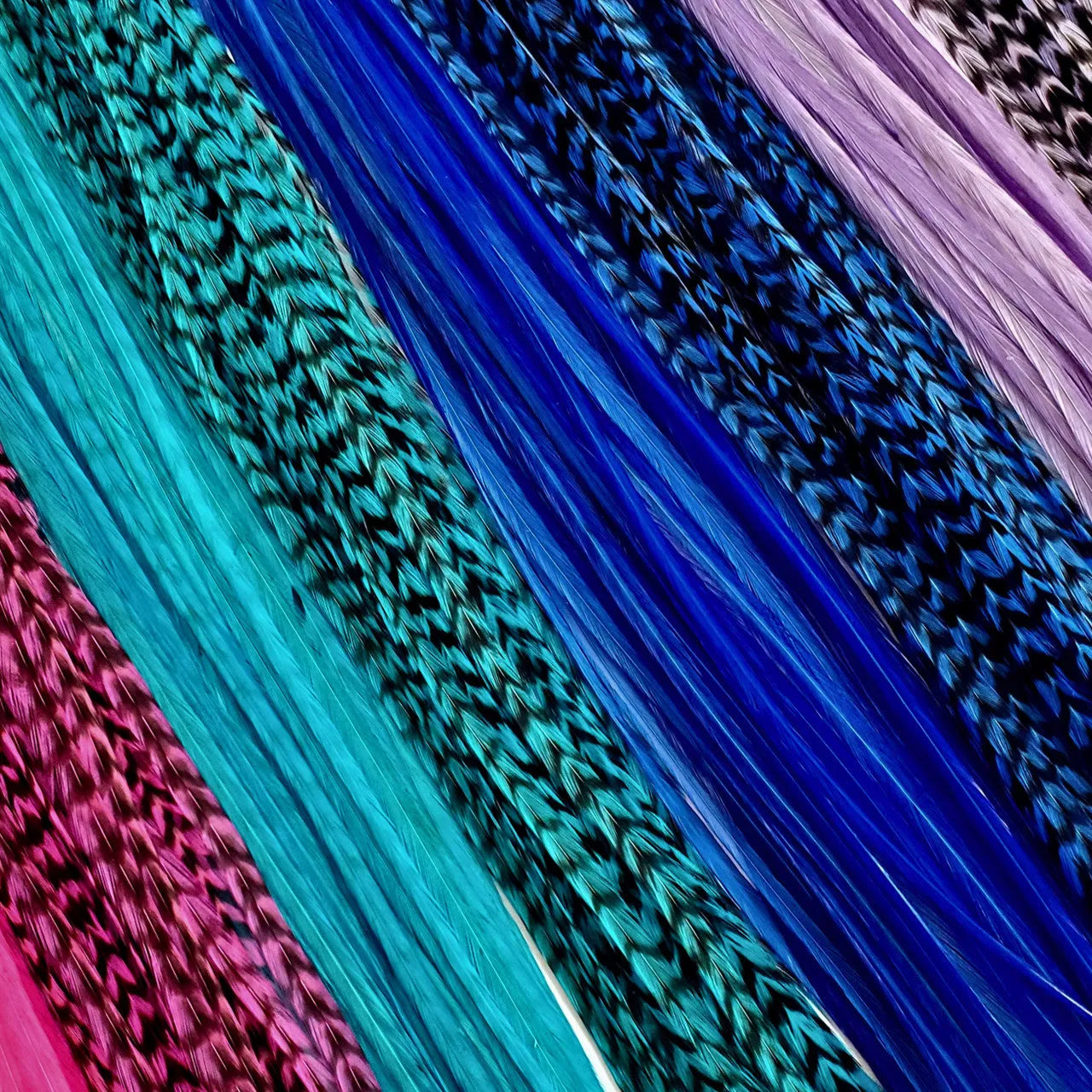 Unleash your inner beach babe with our "Beach Party" Hair Feather Pack. These vibrant and playful hair accessories are the perfect way to add a touch of summer to your everyday look. With a mix of pink, purple, blue, and turquoise feathers, you'll feel like you're dancing on the shore, even if you're miles away from the beach!
