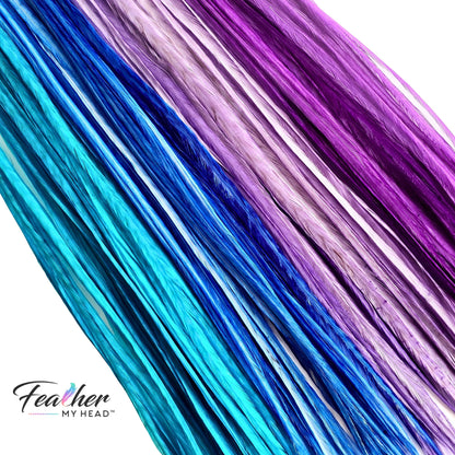 close up of blue purple turquoise feather hair extensions dancing waters mix