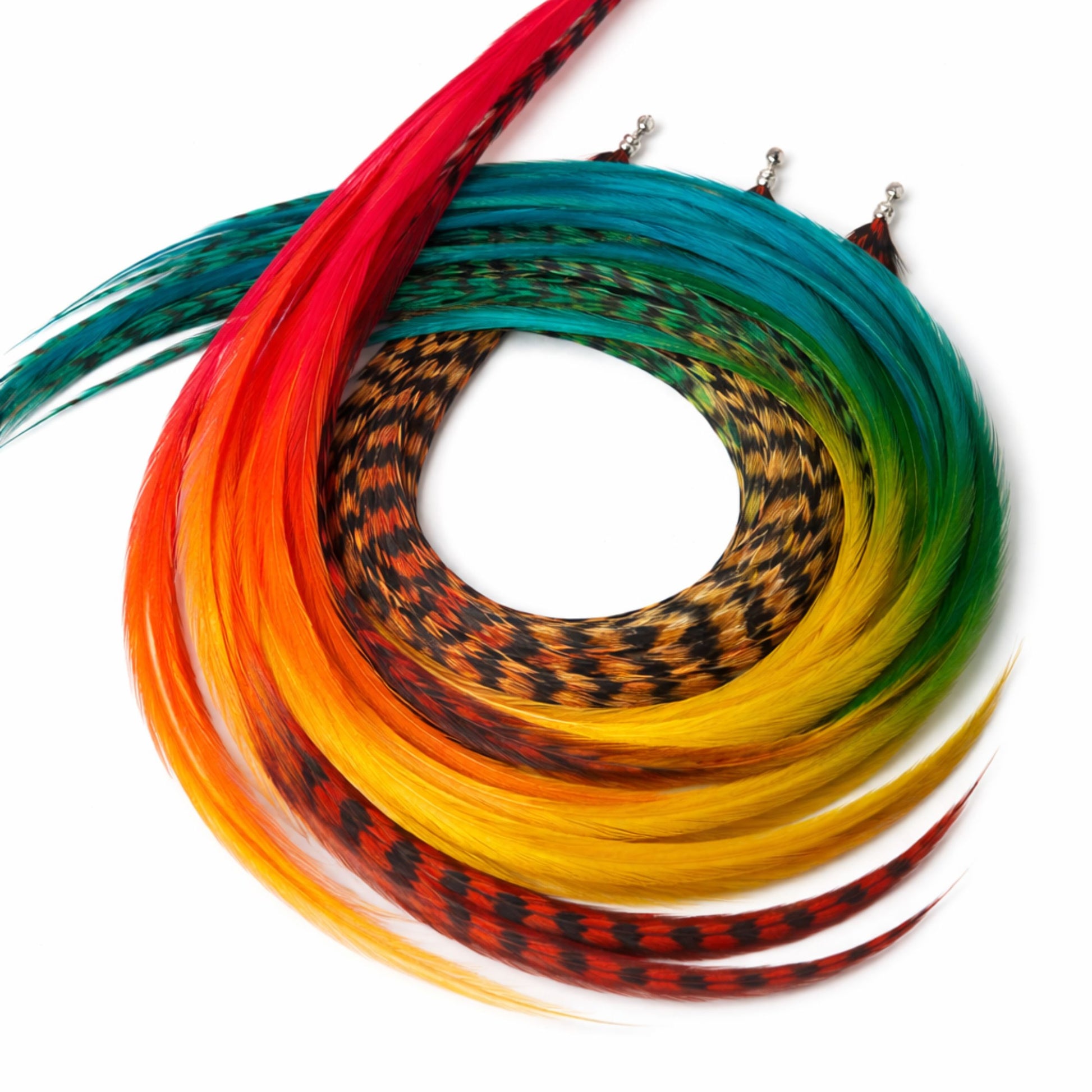 Durango hair feather extensions in earthy rainbow shades of red, burnt orange, cream, and turquoise with black grizzly pattern detail.