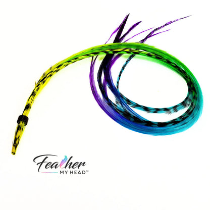 Our Snow Cone hair feather extensions are inspired by the swirled, icy treat that turns every tongue a different shade. Each hand-dyed feather blends vivid tones of purple, blue, green, and yellow, creating a stunning tie-dye effect.