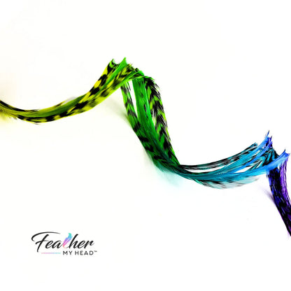 Our Snow Cone hair feather extensions are inspired by the swirled, icy treat that turns every tongue a different shade. Each hand-dyed feather blends vivid tones of purple, blue, green, and yellow, creating a stunning tie-dye effect.