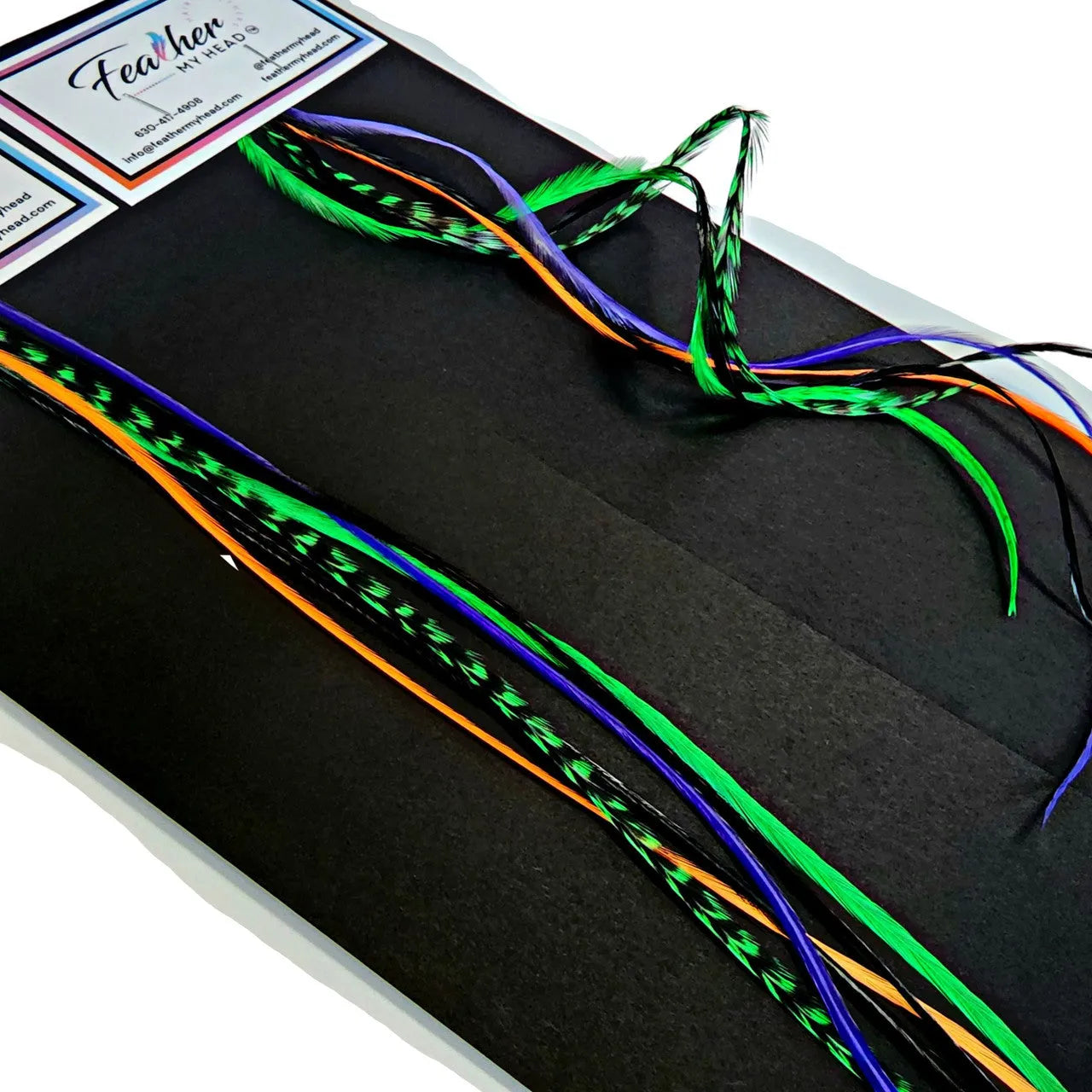 Feather Hair Extension Kit by Feather My Head. Mix of  orange, purple, black feathers and green.  Real hair feathers in long lengths. Halloween costume accessory