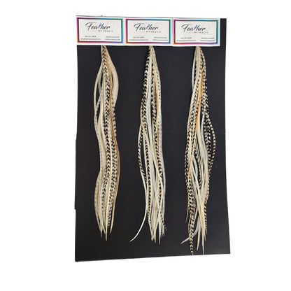 Island Girl feather hair extensions shown on display cards in soft cream, beige, and natural variegated tones