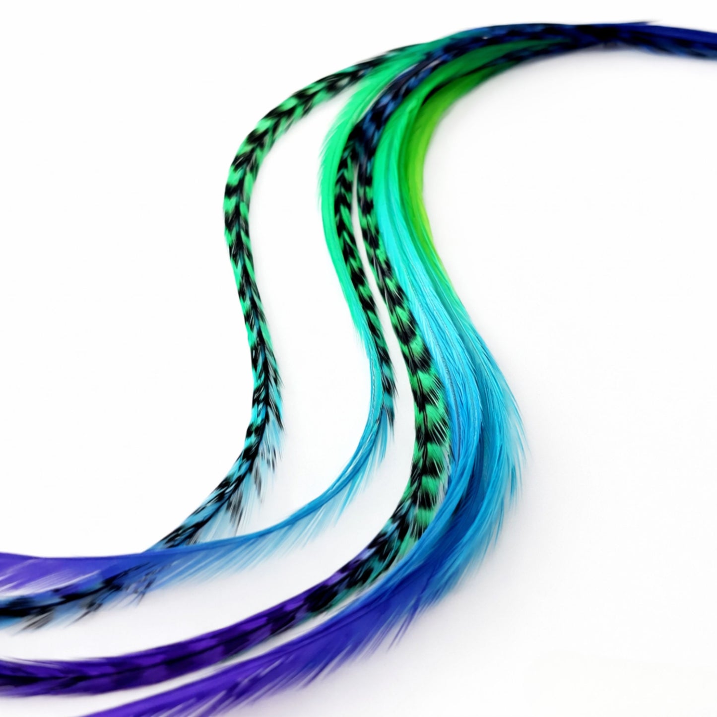 close up real feather hair extensions showing natural texture and color blend purple green blue