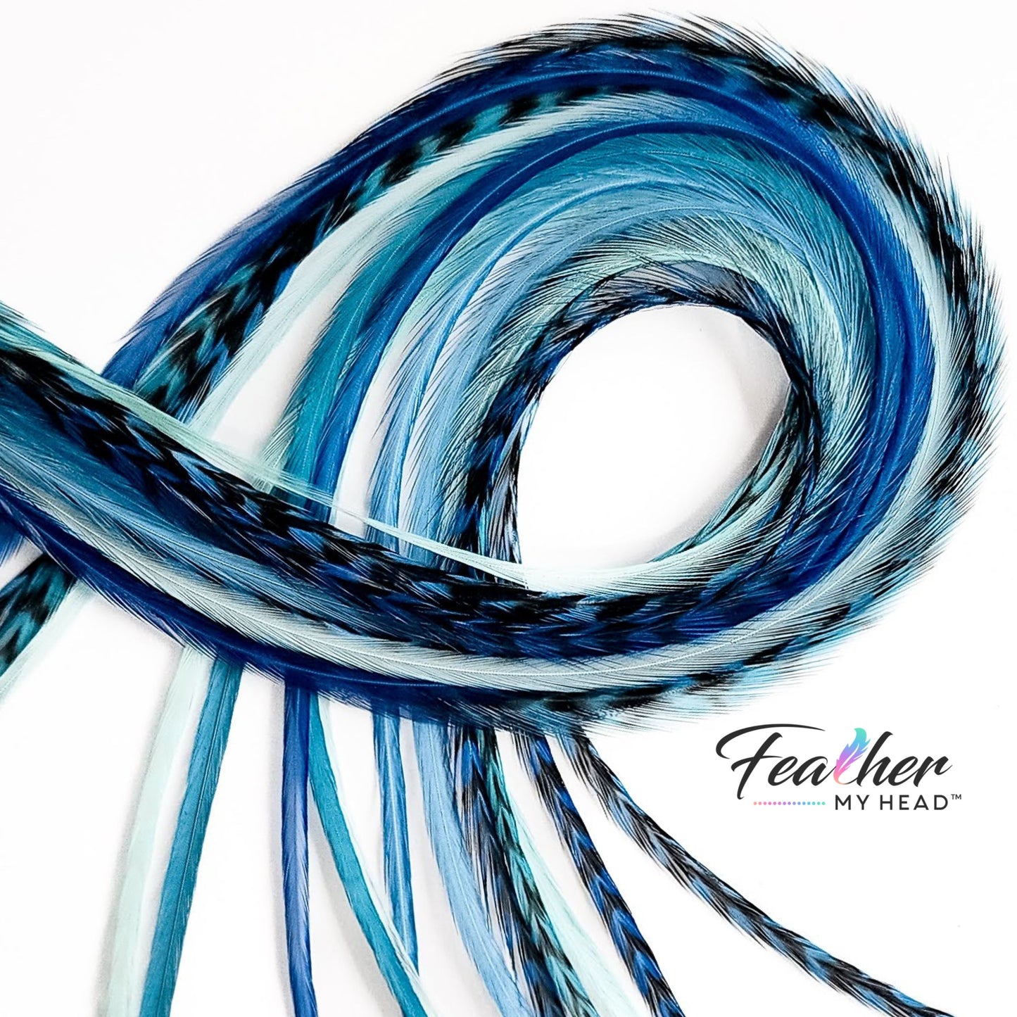 Coiled Sea Glass feather hair extensions showing soft blue and aqua tones with natural movement