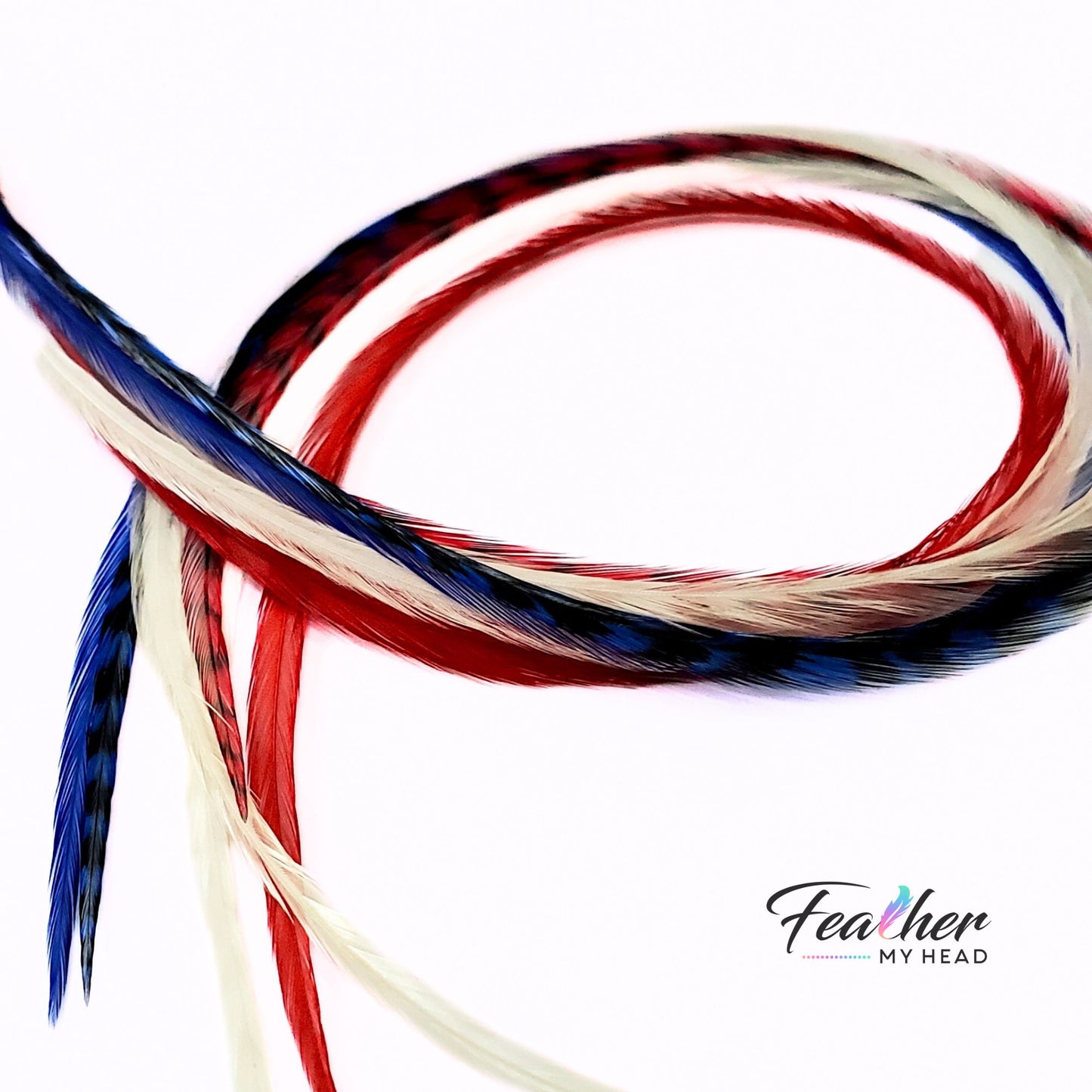 Flat lay of red white and blue feather hair extensions showing length and color mix
