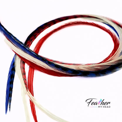 Flat lay of red white and blue feather hair extensions showing length and color mix