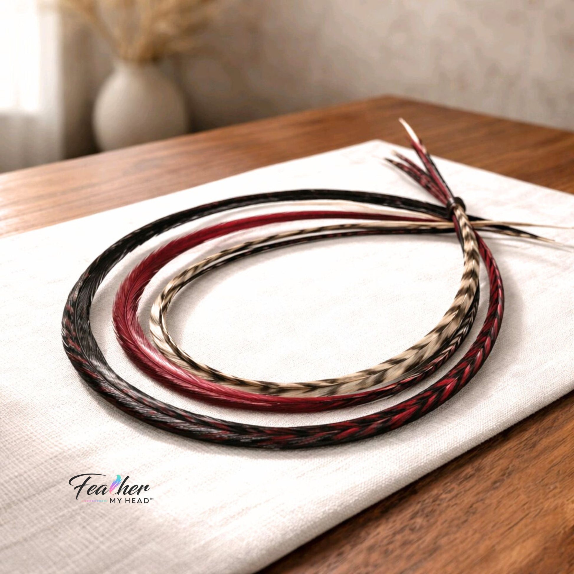 Sedona feather hair extension mix featuring deep red, burgundy, black, and brown rooster feathers.