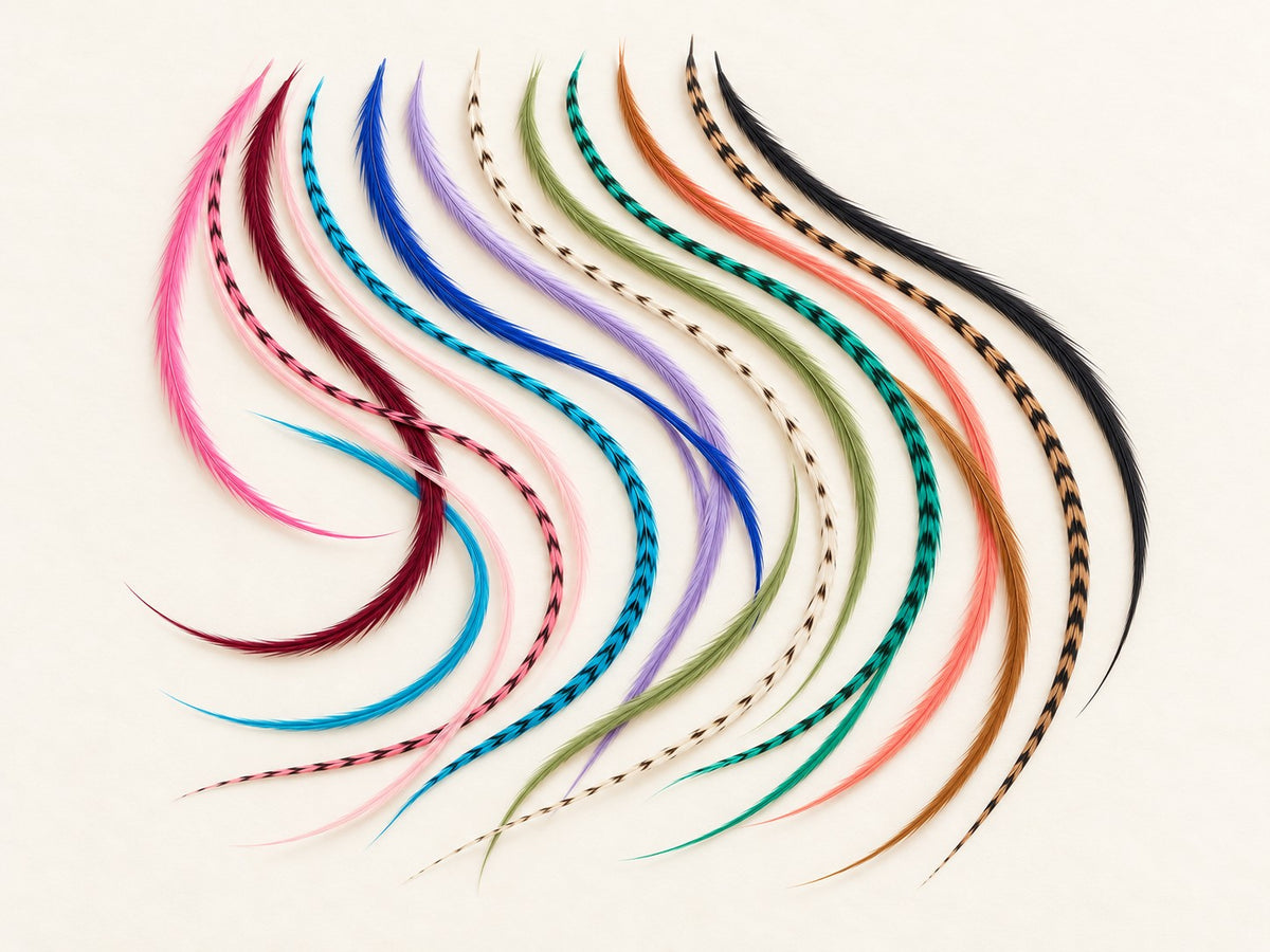 Long slender feather hair extensions in pink, blue, purple, green, coral, brown, cream and black arranged on an ivory background
